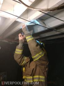 Firefighter/Bunk-in Dalton Majors installing a smoke detector